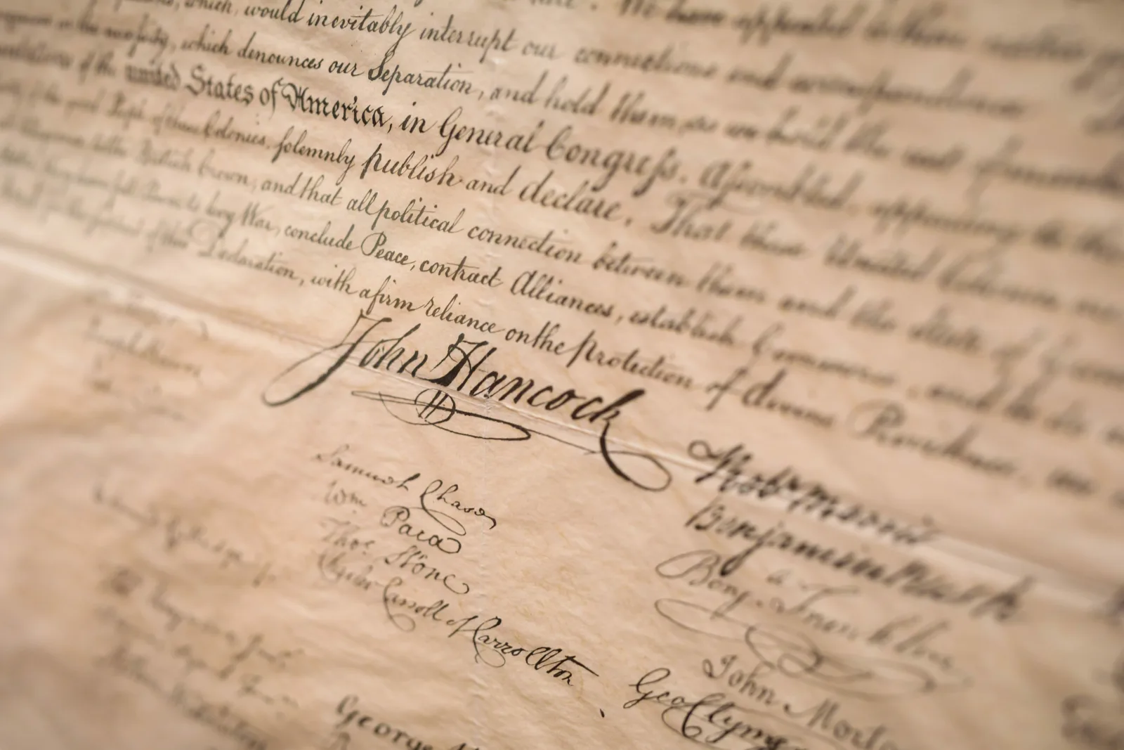 : John Hancock’s iconic signature appears below the text of the Declaration of Independence.