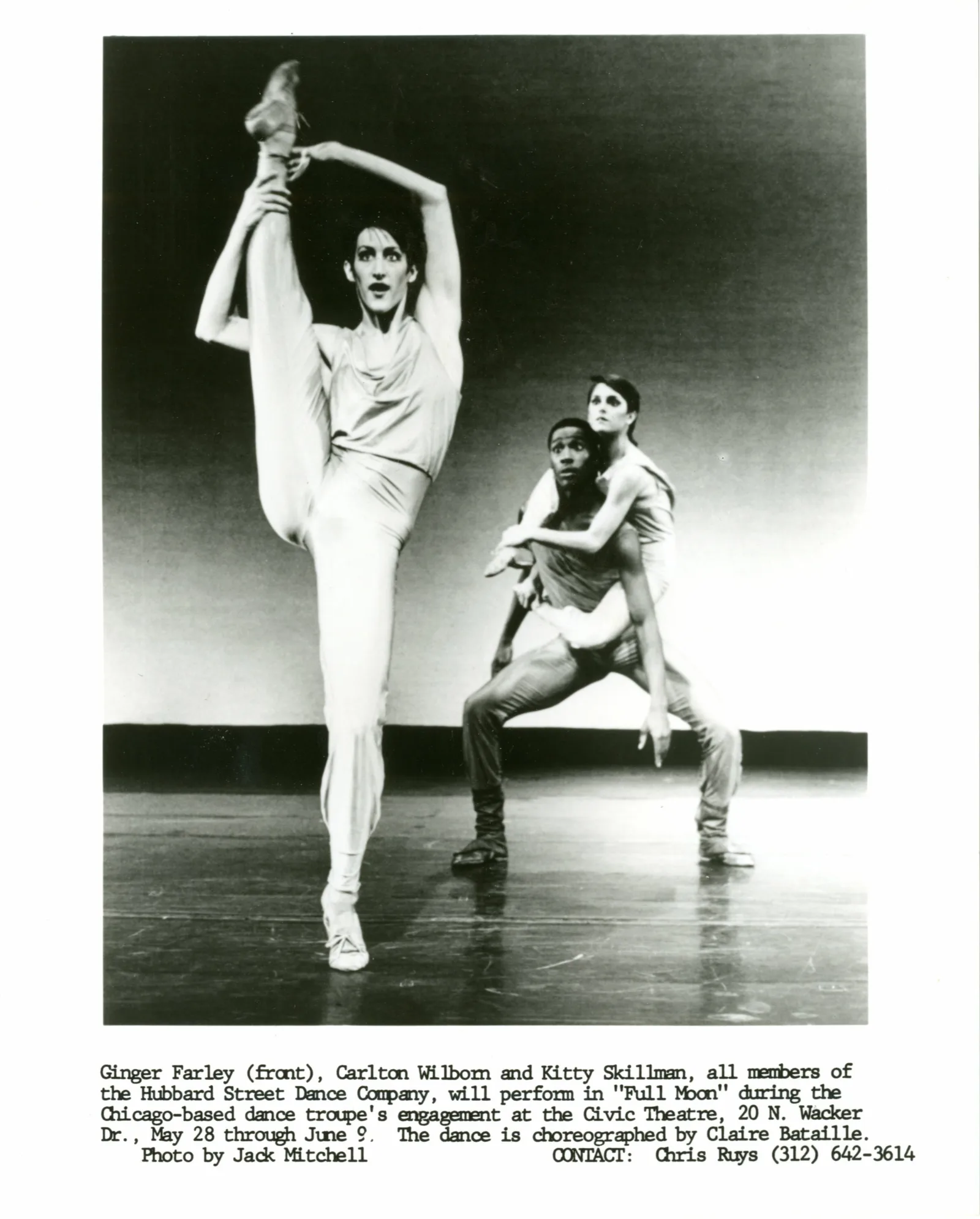 One dancer in foreground holds leg over head, second dancer in background holds third dancer on his back, both gazing at the dancer in the foreground.