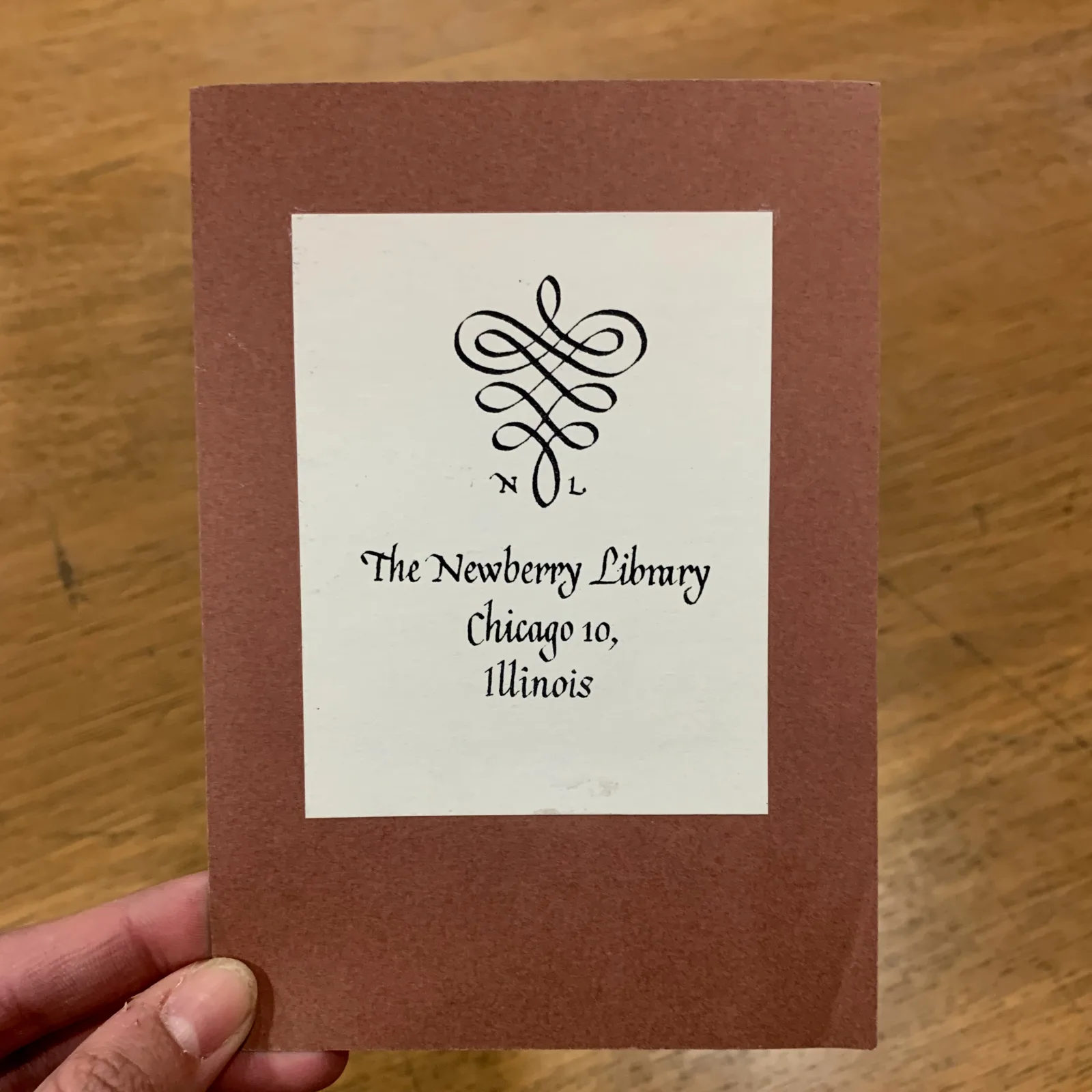 The bookplate reads, "The Newberry Library, Chicago 10, Illinois." At the top is a spiral design with "N" and "L" on either side.
